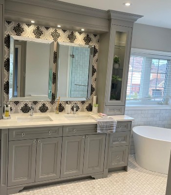 two white color washbasins and two big face mirror in washroom